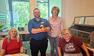 Leiter und Gäste der Tagespflege mit Meerschweinchen Francesco. 